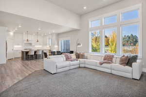 Living area with plenty of natural light, recessed lighting, and light wood-type flooring