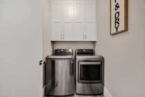 Laundry room with cabinet space and independent washer and dryer