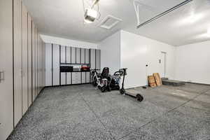 Garage featuring a garage door opener