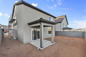 Back of property with a patio, stucco siding, and a fenced backyard