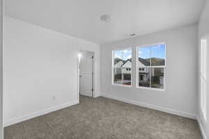 Spare room with baseboards and carpet floors