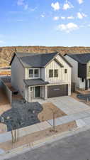 Modern farmhouse featuring concrete driveway, board and batten siding, a garage, a shingled roof, and a mountain view