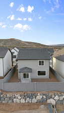 Back of property featuring a fenced backyard, stucco siding, and a mountain view