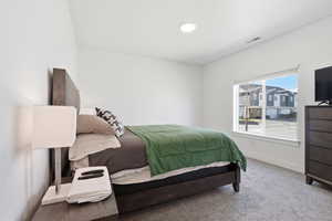 Primary Bedroom with carpet floors and baseboards
