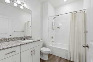 Full bath featuring extra long vanity,, shower / bath combination with curtain, and recessed lighting