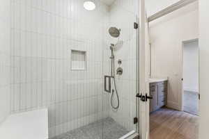 Full bath with a stall shower and vanity