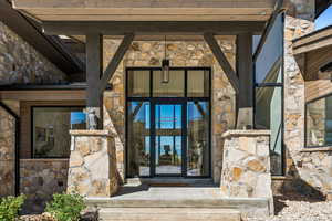 View of exterior entry featuring stone siding