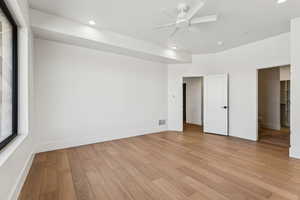 Unfurnished bedroom with light wood-style floors, a ceiling fan, and recessed lighting