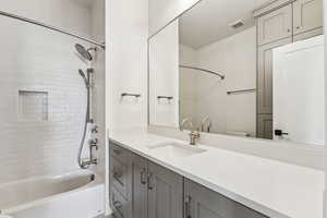 Bathroom featuring bathtub / shower combination and vanity