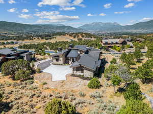 Aerial view of property and surrounding area with mountains