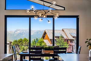 Dining space with a mountain view and a chandelier