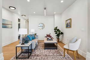 Living room with light wood-style floors and recessed lighting