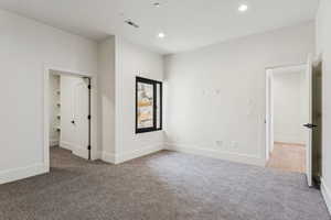 Unfurnished bedroom with carpet flooring and recessed lighting