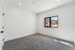 Carpeted spare room featuring recessed lighting
