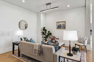 Living room featuring light wood-style floors and recessed lighting