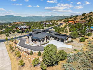 View from above of property with a mountain backdrop