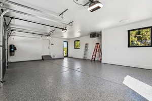 Garage featuring a heating unit and a garage door opener