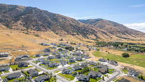 Aerial view of residential area featuring a mountainous background