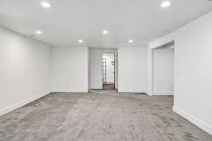 Spare room featuring light carpet and recessed lighting