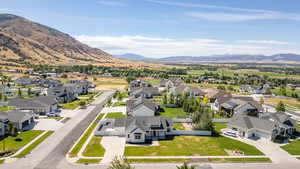 Aerial view of residential area featuring a mountainous background