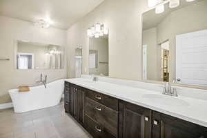 Full bathroom with double vanity and a freestanding bath