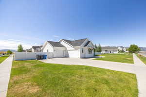 View of front of house with board and batten siding, a residential view, an attached garage, a shingled roof, and driveway