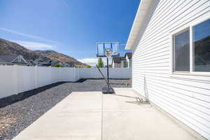 Fenced backyard with a patio area and a mountain view