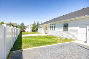 Back of house with a patio area, a residential view, and roof with shingles