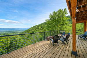 Wooden deck featuring a wooded view