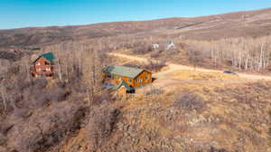 Aerial view of property and surrounding area with a mountainous background