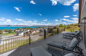 Wooden deck featuring a patio area, a mountain view, and a residential view