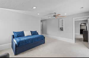 Bedroom with light carpet, recessed lighting, and a ceiling fan