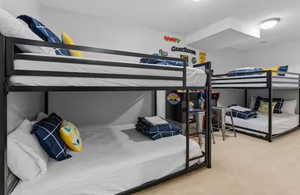 Bedroom featuring light carpet