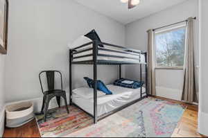 Bedroom with wood finished floors and ceiling fan