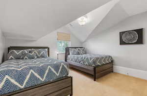 Bedroom featuring carpet floors and lofted ceiling