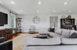 Living room with recessed lighting and wood finished floors