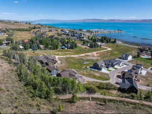 Aerial view of residential area featuring a nearby body of water