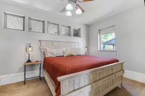 Bedroom with ceiling fan and carpet flooring