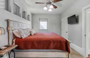Bedroom with ceiling fan and baseboards