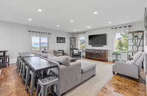 Living area with light wood finished floors, plenty of natural light, and recessed lighting