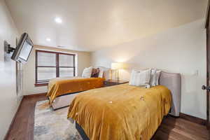 Bedroom with dark wood-type flooring and recessed lighting