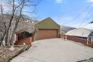 Garage featuring concrete driveway and a mountain view