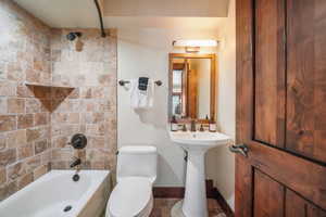 Bathroom featuring toilet and shower / bathtub combination