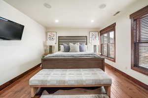 Bedroom with hardwood / wood-style floors