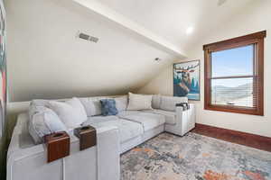 Living room featuring lofted ceiling and wood finished floors