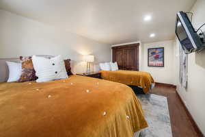 Bedroom with wood finished floors and recessed lighting