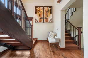 Stairway featuring hardwood / wood-style floors and baseboards