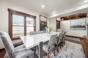 Dining room featuring dark wood-type flooring and recessed lighting