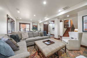 Living room featuring recessed lighting and stairway