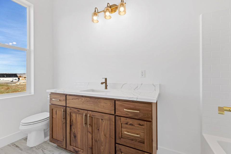 Full bath featuring vanity and toilet